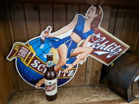 A Shiltz beer metal advertising sign and bottle torch.