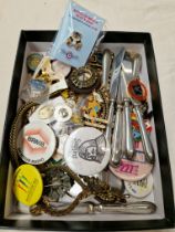 A box of mixed collectables including silver handled butter knives, vintage badges, costume