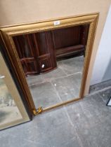 A gilt framed mirror.