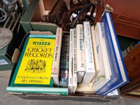A box of assorted books on cricket.