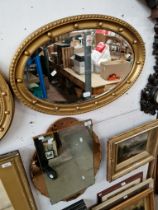 A 1930s Art Deco wall mirror with peach glass panels, 45cm x 68cm, together with an oval gilt framed