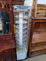A Timex rotating watch display cabinet.
