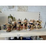 A collection of 13 ceramic steins.