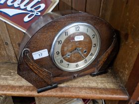 An oak cased mantle clock with key and pendulum