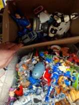 Two boxes of assorted toy figures.