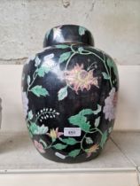 Large oriental lidded ginger /storage jar - flower pattern on black ground. Height appx 40cm