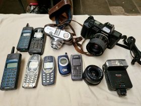 Assorted mobile phones and cameras including a Voigtlander, a Chinon CP-7, Nokia, Ericsson etc.