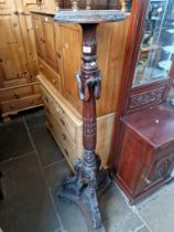 A carved mahogany plant stand.