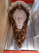 An Art Nouveau style composite wall sconce modelled as a lady's head.
