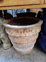 A terracotta planter together with chimney pot cover