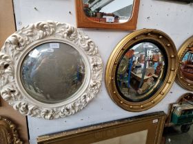 A Regency style gilt framed convex mirror together with another convex mirror.