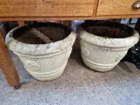 2 large circular concrete planters