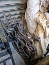 Two cast iron bench ends decorated with dogs, serpents and grapes, with back, as found,