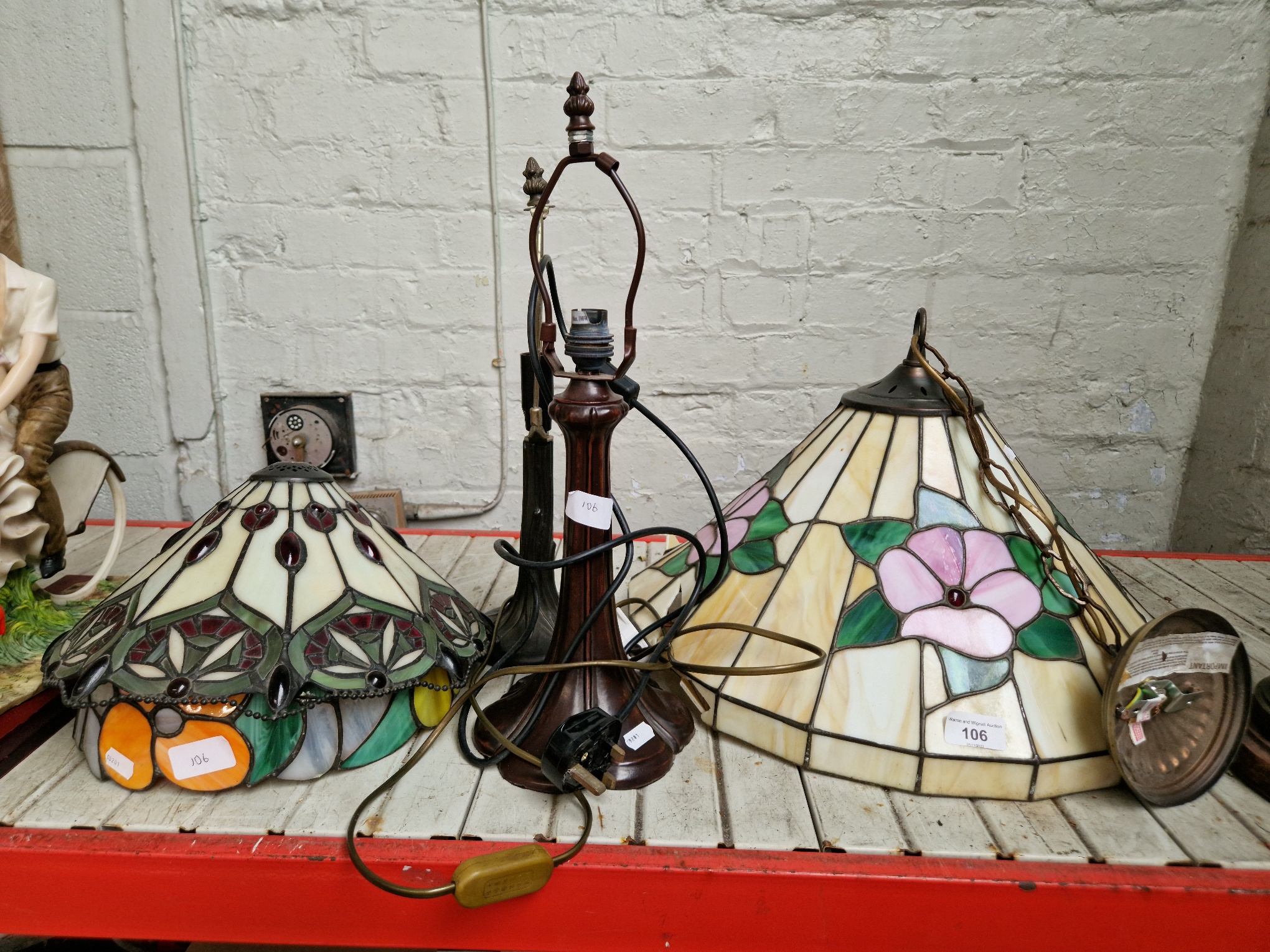 Three Tiffany style lamps with shades and one ceiling light fitting which has some damage to the