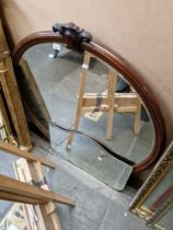 A mahogany framed circular mirror.