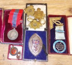 Assorted medals and badges including a service medal awarded to John Edward Owen, two silver