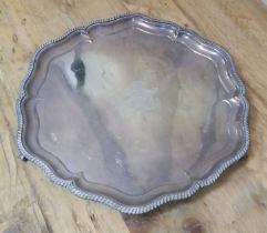 A George V four footed silver salver, gadrooned edge, central crest 'Spero', Walker & Hall,