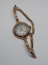 A ladies 9ct gold wristwatch with strap marked '9ct', gross wt. 22.3g.