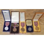 Assorted ice skating medals including silver.