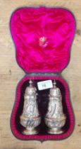 A matched cased pair of Victorian silver pepper pots, Josiah Williams & Co, London 1889 & 1899 wt.