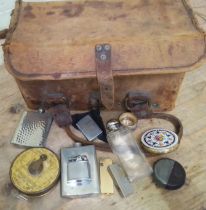 A vintage tool bag containing assorted collectables to include a lawn tennis measure, hip flasks,