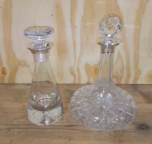 Two glass decanters with hallmarked silver collars.