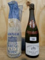 Two bottles of Krug & Co. Private Cuvée Brut Reserve Champagne, some slight seepage, levels good.