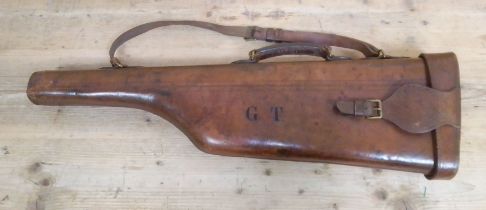 A brown leather leg of mutton shotgun case.