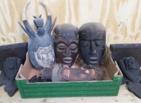 A box of assorted wooden masks and a pair of brackets.