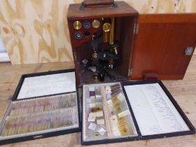 A W Watson & Sons microscope with mahogany case, lenses, and two cases of slides.