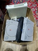 A box containing 2 Playstations, PS2, Xbox360 with various accessories and games.