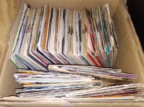 A box of assorted vinyl singles, various artists & genres.