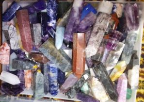 A box of crystal, polycrystalline and man made fashioned obelisks.