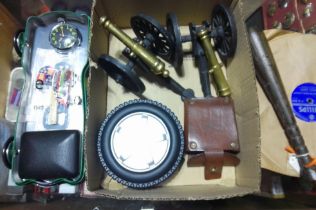 A box of assorted collectables including a pair of miniature cannons, a fishing preist etc.