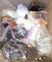 A box of assorted mineral samples including crystals and fashioned samples.