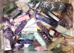 A box of assorted crystal, polycrystalline and man made fashioned obelisks.