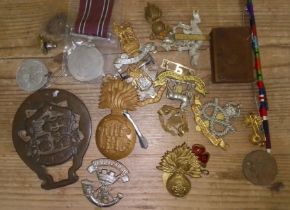 A box of assorted medals and badges.