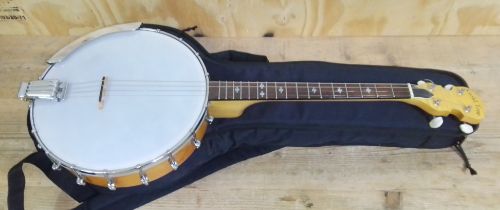 A Gold Tone four string banjo, with soft case.