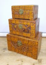 A set of three graduated Eastern carved camphor wood boxes.