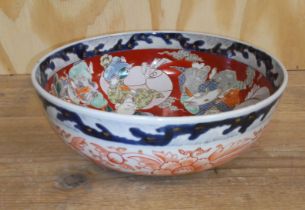 A Japanese Imari bowl, 19th century, the interior decorated with figures, four character mark to