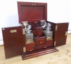 An early 20th century mahogany smoker's cabinet/decanter box, labelled Waring & Gillow, assorted