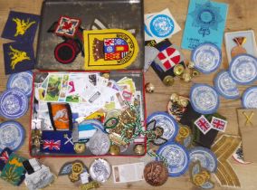 A quantity of mainly military cloth badges and other collectables.