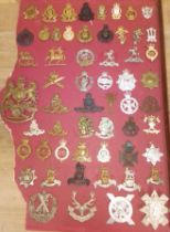 Approx. 57 cap badges.