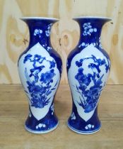 A pair of Chinese porcelain vases, each bearing four character Kangxi mark to base, height 26cm.