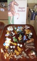 A tray of Hagen-Renaker California miniature animals with a book.