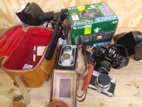 A box of cameras and accessories including a Weltaflex medium format camera, a CanonA-1 etc.