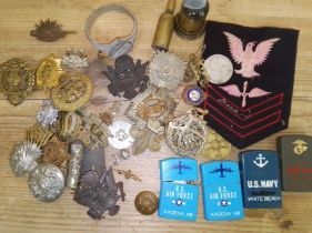 A mixed lot of mainly cap badges etc, together with eye shield goggles and buttons, photographs.