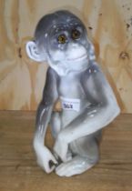 An Italian novelty porcelain monkey with light up eyes, Capodimonte style Naples mark to base,