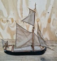 A scratch built wooden model of a sailing barge.