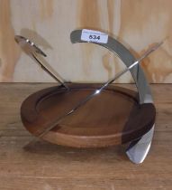 A modern silver plated and wooden bottle coaster designed by Robert Welch, height 13cm.